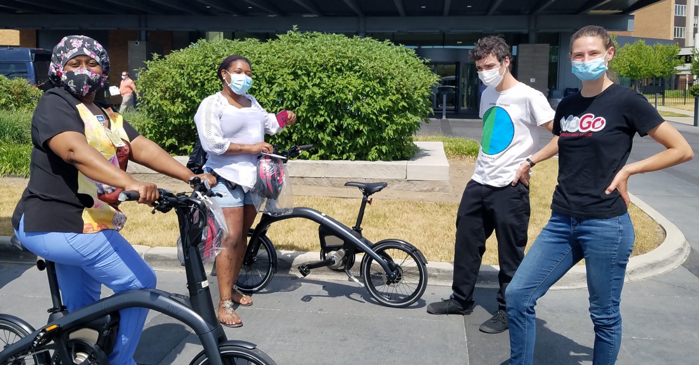 A photo of public health workers in Detroit receiving MoGo e-bikes to expand their access to safe, affordable mobility during COVID-19 response efforts